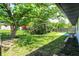 Fenced yard features patio, tall trees, and green landscaping at 3237 Thurston Dr, Indianapolis, IN 46224