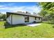 Back of home with yard, patio, fenced area, and mature shade tree at 3237 Thurston Dr, Indianapolis, IN 46224