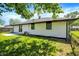 Back of home with fenced yard, patio, and mature shade trees at 3237 Thurston Dr, Indianapolis, IN 46224