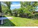 Open fenced yard with a patio and mature shade trees at 3237 Thurston Dr, Indianapolis, IN 46224