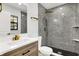 Updated bathroom features granite-look tiled shower and floor plus a wood vanity with granite at 3237 Thurston Dr, Indianapolis, IN 46224