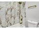 Shower area with white marble-patterned tiles and gold hardware at 3237 Thurston Dr, Indianapolis, IN 46224