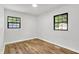 Bedroom features wood-look floors, neutral paint, and natural light from the windows at 3237 Thurston Dr, Indianapolis, IN 46224