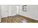 Bedroom with wood floors, black window trim, and a closet at 3237 Thurston Dr, Indianapolis, IN 46224