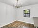 Dining room with wood floors, a modern chandelier, and a window with natural light at 3237 Thurston Dr, Indianapolis, IN 46224