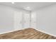 A bright entryway with fresh paint, three doors and new wood-look floors at 3237 Thurston Dr, Indianapolis, IN 46224