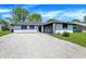 Charming single-story home with a well-maintained lawn and gravel driveway at 3237 Thurston Dr, Indianapolis, IN 46224