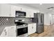 Updated kitchen with stainless steel appliances, stylish backsplash, and ample cabinet space at 3237 Thurston Dr, Indianapolis, IN 46224