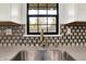 Close up of modern kitchen sink with stainless steel faucet and stylish backsplash at 3237 Thurston Dr, Indianapolis, IN 46224