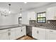 Open kitchen with granite countertops, stainless steel appliances, and a stylish lighting fixture at 3237 Thurston Dr, Indianapolis, IN 46224