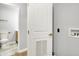 Laundry area with white door and view into the bathroom at 3237 Thurston Dr, Indianapolis, IN 46224