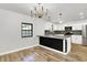 Bright, open-concept kitchen and living area featuring stainless steel appliances and hardwood floors at 3237 Thurston Dr, Indianapolis, IN 46224