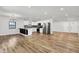 Open-concept living room and kitchen featuring hardwood floors, recessed lighting, and stainless steel appliances at 3237 Thurston Dr, Indianapolis, IN 46224