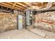 Exposed basement with water heater, HVAC unit, and brick foundation walls at 353 S Indiana St, Danville, IN 46122