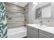 Well-lit bathroom features a modern vanity, framed mirror, and shower-tub combo with tiled surround at 353 S Indiana St, Danville, IN 46122