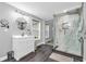 Bright bathroom featuring stylish vanity, large shower with decorative tiles, and wood-look floors at 353 S Indiana St, Danville, IN 46122