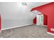 Bedroom featuring gray walls, red accent wall, carpet, modern lighting and a window with natural light at 353 S Indiana St, Danville, IN 46122