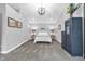 Bedroom features neutral walls, carpeted floors, decorative lighting, and a vintage armoire for added charm at 353 S Indiana St, Danville, IN 46122