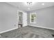 Inviting bedroom with plush carpet, neutral paint, window, and doorway to another room at 353 S Indiana St, Danville, IN 46122