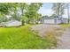 Charming home with a large driveway, lush lawn, and a detached garage, surrounded by mature trees at 353 S Indiana St, Danville, IN 46122