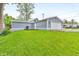 View of the detached garage with light blue siding, white trim, and well-kept lawn at 353 S Indiana St, Danville, IN 46122