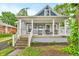 Charming home featuring a covered porch with white columns and an inviting entrance with blue accents at 353 S Indiana St, Danville, IN 46122
