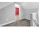Neutral hallway with carpet leading to a room featuring bold red walls and white trim at 353 S Indiana St, Danville, IN 46122