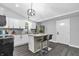 Updated kitchen boasts stainless steel appliances, granite countertops, and a stylish center island with bar stool seating at 353 S Indiana St, Danville, IN 46122