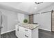 Kitchen island featuring granite top, bar stool seating, and storage space, plus a view of the adjacent sliding door at 353 S Indiana St, Danville, IN 46122