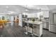 Open-concept kitchen features an island with barstool seating, stainless appliances, and connects to a cozy living area at 353 S Indiana St, Danville, IN 46122