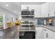 This kitchen is equipped with stainless appliances and granite countertops, offering a peek into the cozy living area at 353 S Indiana St, Danville, IN 46122