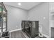 A functional laundry room featuring modern, stainless steel, front-load washer and dryer at 353 S Indiana St, Danville, IN 46122