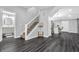 Open living space with hardwood floors, staircase and a modern kitchen visible at 353 S Indiana St, Danville, IN 46122