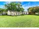 Large backyard with detached outbuilding, garage and green lawn at 356 Daugherty St, Columbus, IN 47201