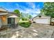 Wide backyard with a large detached garage featuring a basketball hoop on a sunny day at 356 Daugherty St, Columbus, IN 47201