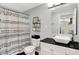 Modern bathroom with a vanity, toilet, and patterned shower curtain, creating a clean and stylish space at 356 Daugherty St, Columbus, IN 47201