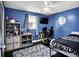 Bedroom features a ceiling fan, window, and dark blue walls at 356 Daugherty St, Columbus, IN 47201