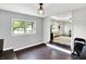 A dining room with hardwood floors, neutral walls, and an open view of the front living room and a large window at 356 Daugherty St, Columbus, IN 47201