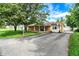 Front exterior showcasing the long driveway and the brick/siding combination on this beautiful one-story home at 356 Daugherty St, Columbus, IN 47201