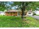 Charming brick home with a well-maintained lawn, a front porch, and mature trees creating curb appeal at 356 Daugherty St, Columbus, IN 47201