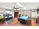 Functional garage with a pool table, dining setup, and storage solutions, offering a versatile space at 356 Daugherty St, Columbus, IN 47201