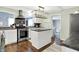 Modern kitchen with center island, stainless steel range, and black subway tile backsplash at 356 Daugherty St, Columbus, IN 47201