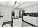 Kitchen area featuring black appliances, center island, and white cabinetry at 356 Daugherty St, Columbus, IN 47201