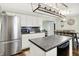 Well-lit kitchen with stainless steel refrigerator, island with seating and sleek countertops at 356 Daugherty St, Columbus, IN 47201