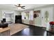 Bright living room featuring hardwood floors, neutral walls, a large window, and a modern ceiling fan at 356 Daugherty St, Columbus, IN 47201