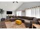 Spacious living room with vaulted ceilings, dark wood floors, and a comfortable sectional sofa at 356 Daugherty St, Columbus, IN 47201