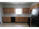 Kitchen featuring wooden cabinets and black appliances at 3908 Roundwood Dr, Indianapolis, IN 46235