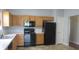 Kitchen featuring wooden cabinets and black appliances at 3908 Roundwood Dr, Indianapolis, IN 46235