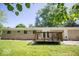 Backyard featuring a wooden deck, a well-manicured lawn, and mature trees at 4023 Cedar Hills South Dr, Greenwood, IN 46143