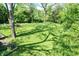 A spacious backyard with manicured lawn, shaded by mature trees at 4023 Cedar Hills South Dr, Greenwood, IN 46143